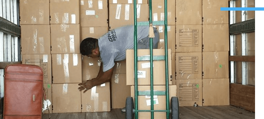 GM Van Lines employee stacking boxes in truck