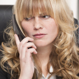 Image of a frustrated woman on the phone